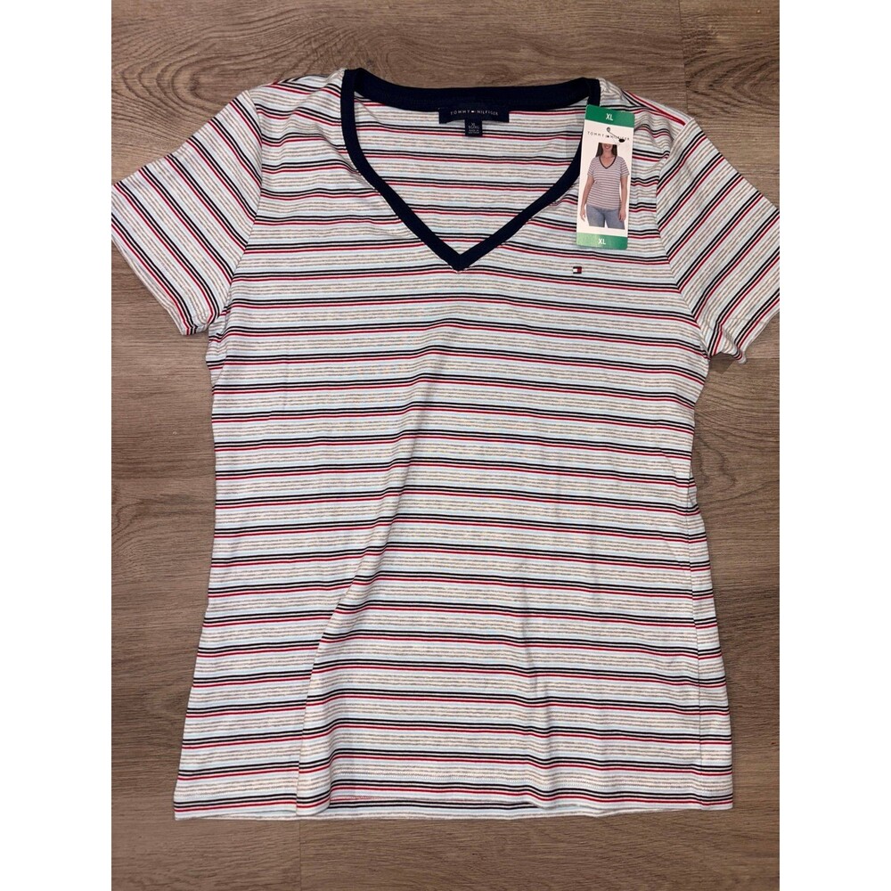 Classic V-neck tee with multicolor stripes. Features Tommy Hilfiger logo detail.